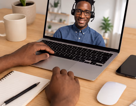 Hands on a laptop keyboard during a video call with an instructor